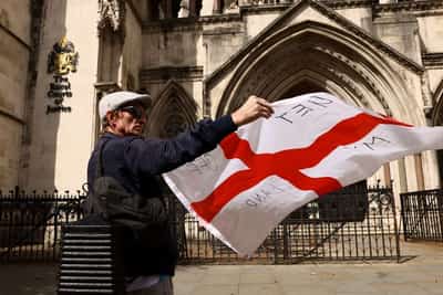 Image for UK wins court ruling to keep asylum seekers in hotel but risks angry response