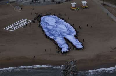Image for Giant portrait of girl killed in Gaza war unfurled on Barcelona beach