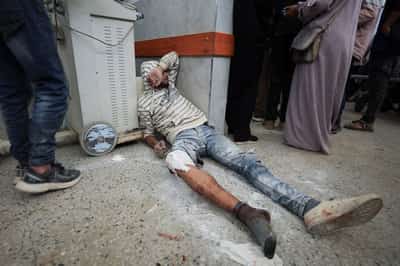 Image for Israeli fire kills 60 in Gaza, many near aid site, medics say