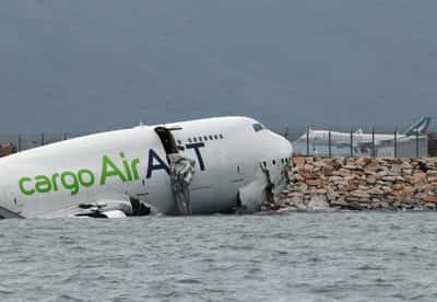 Image for Cargo plane slides off runway in Hong Kong, killing two airport staff