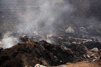 Image for Charred bodies, shattered lives after gunmen kill 100 in Nigeria