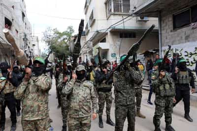 Image for Battling to survive, Hamas faces defiant clans and doubts over Iran