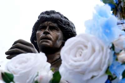 Image for Soccer-Maradona statue rides through Naples as city remembers Argentine great