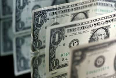 Image for Dollar holds losses as risk appetite flickers ahead of central bank meetings